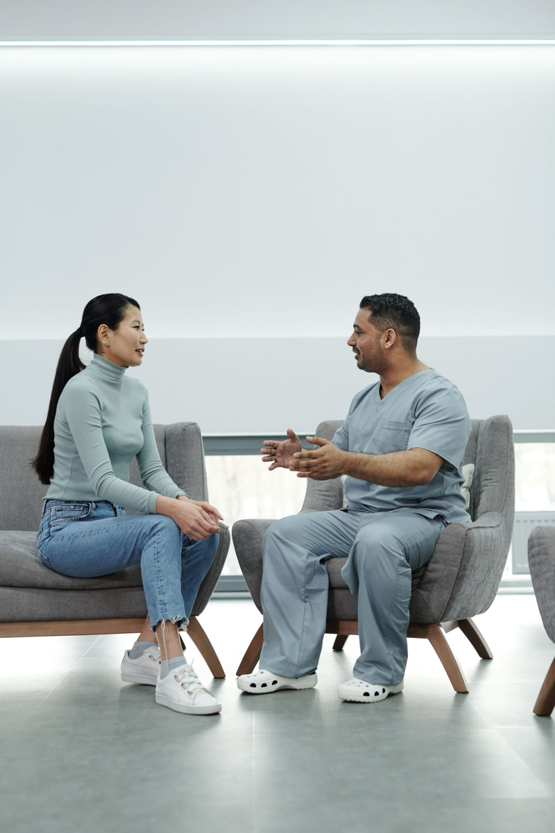 A doctor reviewing a treatment plan with a patient in a bright consultation room